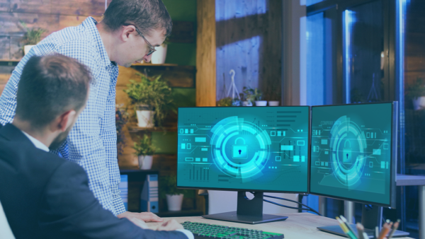 Two men looking at computer monitors with locks displayed on the screen
