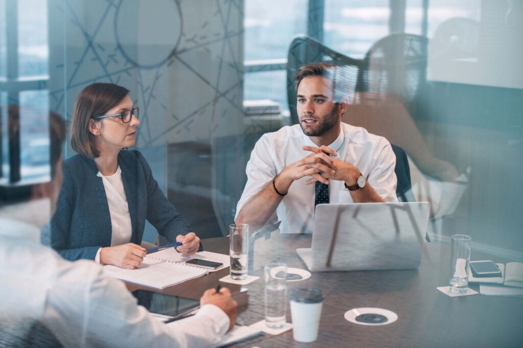 People sitting around a table having a meeting.